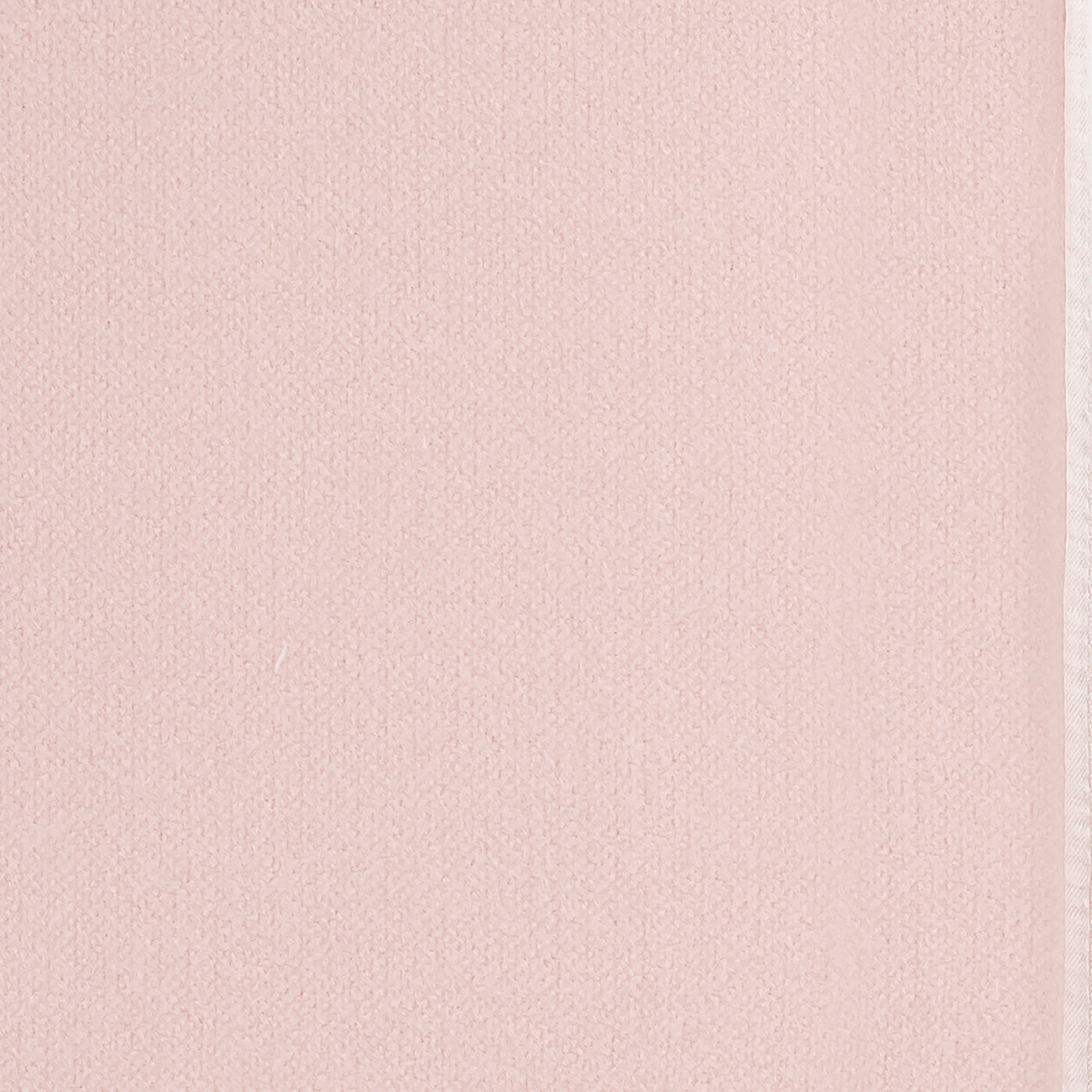 Close-up of blush modal fabric texture with a narrow white trim edge visible.