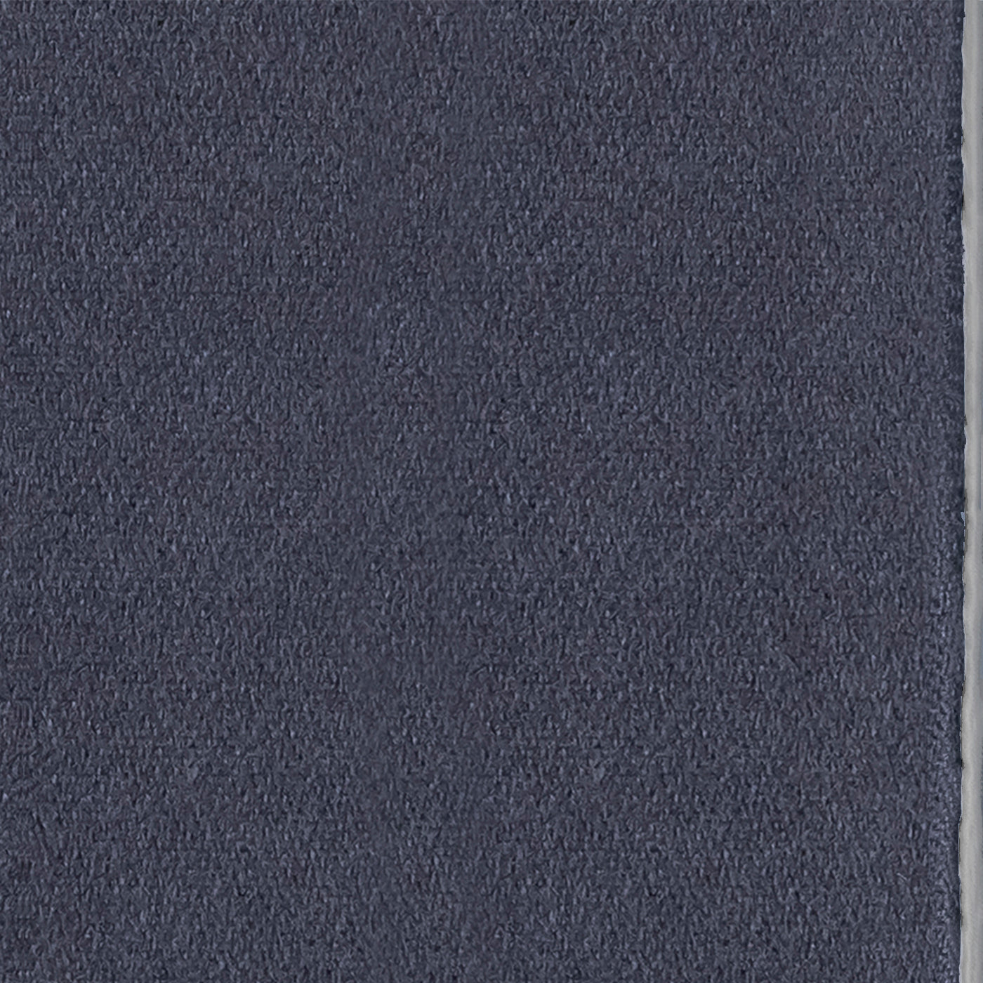 Close-up of navy modal fabric with a narrow silver-grey border edge visible.