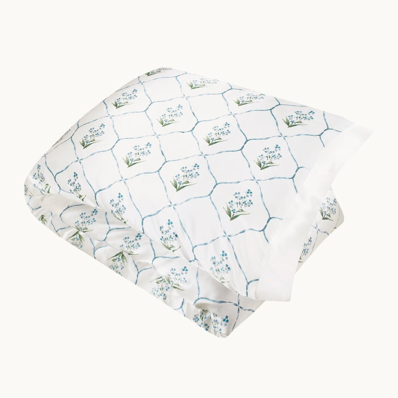 Gingerlily London Forget Me Not silk duvet cover in white with blue trellis floral print.