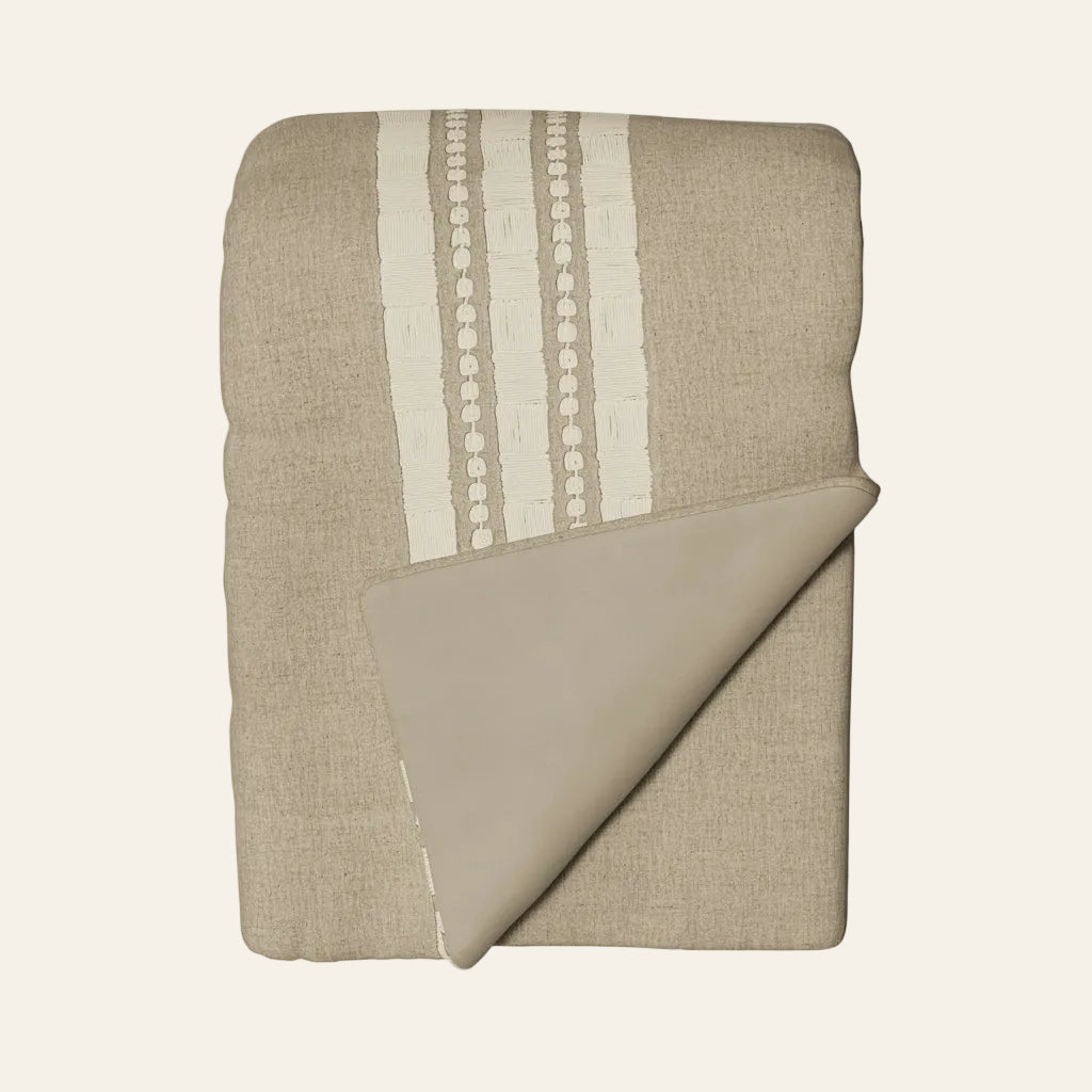 Ann Gish Echelon throw in natural linen with ivory dotted stripe detail, corner folded back.