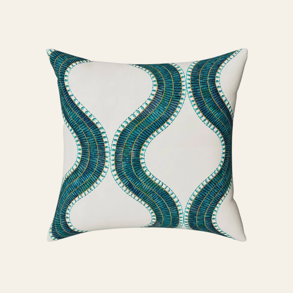 Ann Gish Egyptian Collar pillow in ivory with teal and gold wave embroidery.