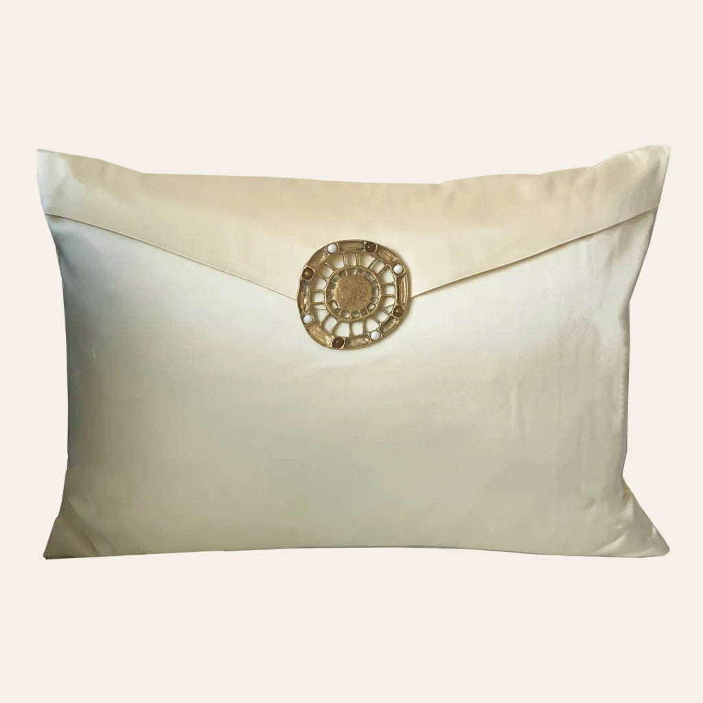 Ann Gish Embellished Etruscan Pillow in ivory silk with envelope flap and gold medallion closure.
