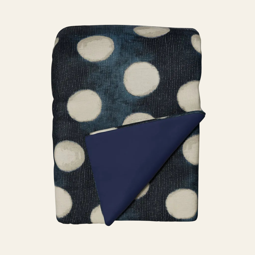 Ann Gish Eclipse throw in navy with ivory polka dots, folded to reveal solid navy reverse.