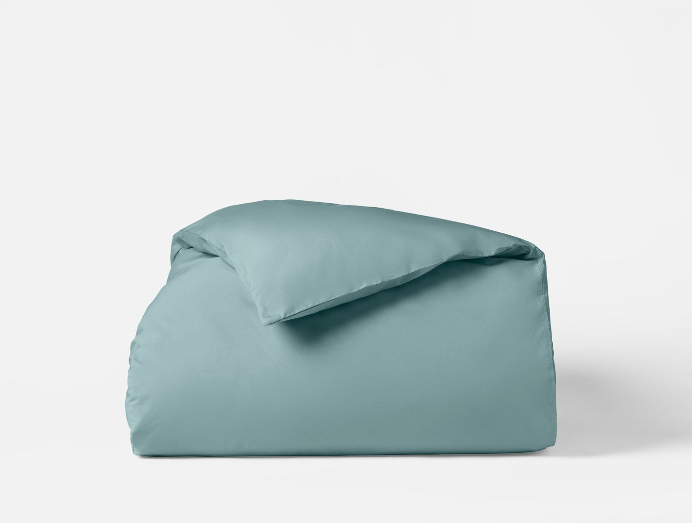 Coyuchi Refined Percale duvet cover folded neatly, shown in muted teal against a white background.