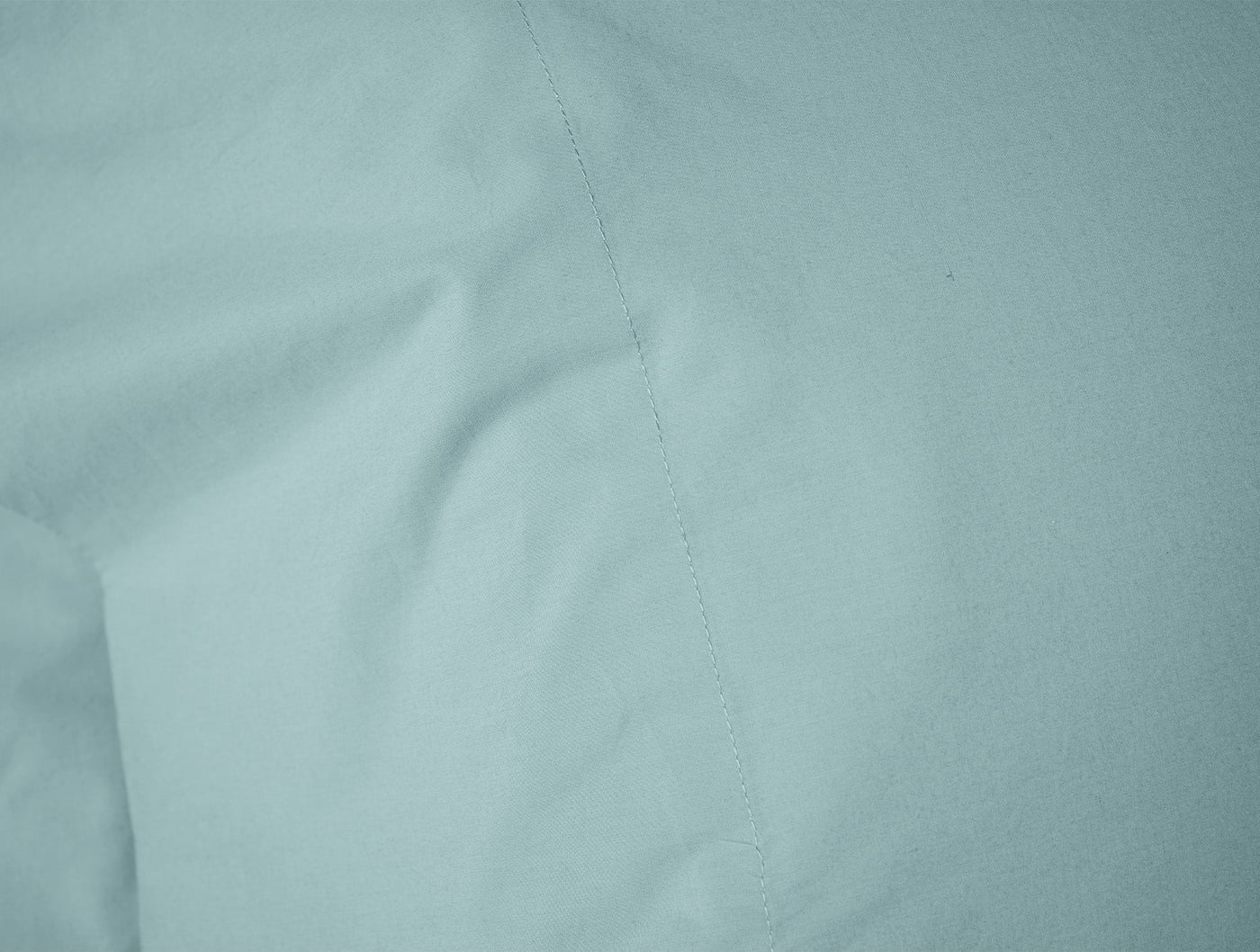 Close-up of Coyuchi Refined Percale pillowcase hem stitching in soft seafoam.