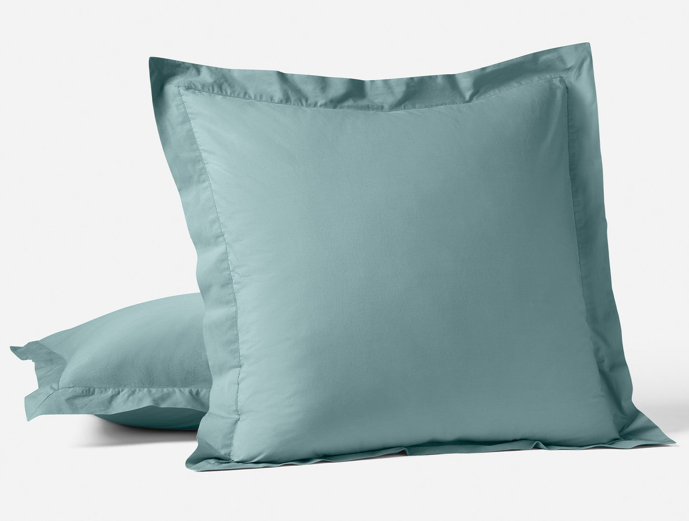Close-up of Coyuchi Refined Percale sham in seafoam with tailored flange border.