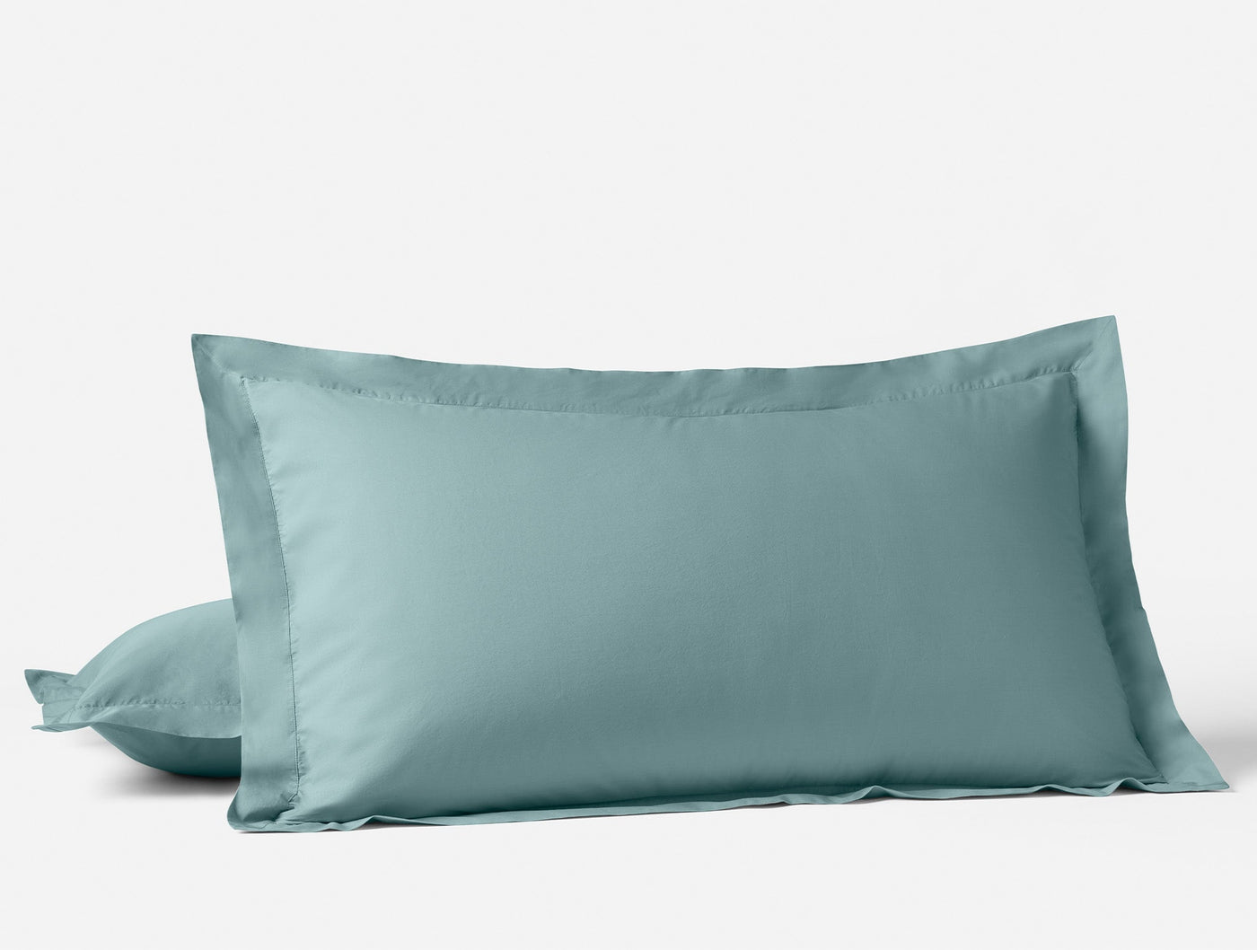 Pair of Coyuchi Refined Percale shams in ocean blue with classic flange border detail.