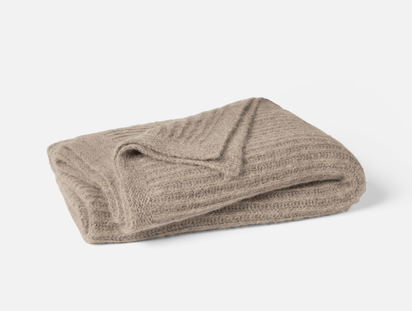 Coyuchi Andes Suri Alpaca Knit throw folded, ribbed texture in warm taupe.