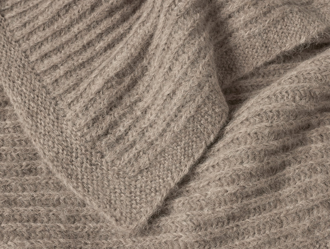 Close-up of Coyuchi Andes Suri Alpaca Knit Throw ribbed texture in warm taupe.