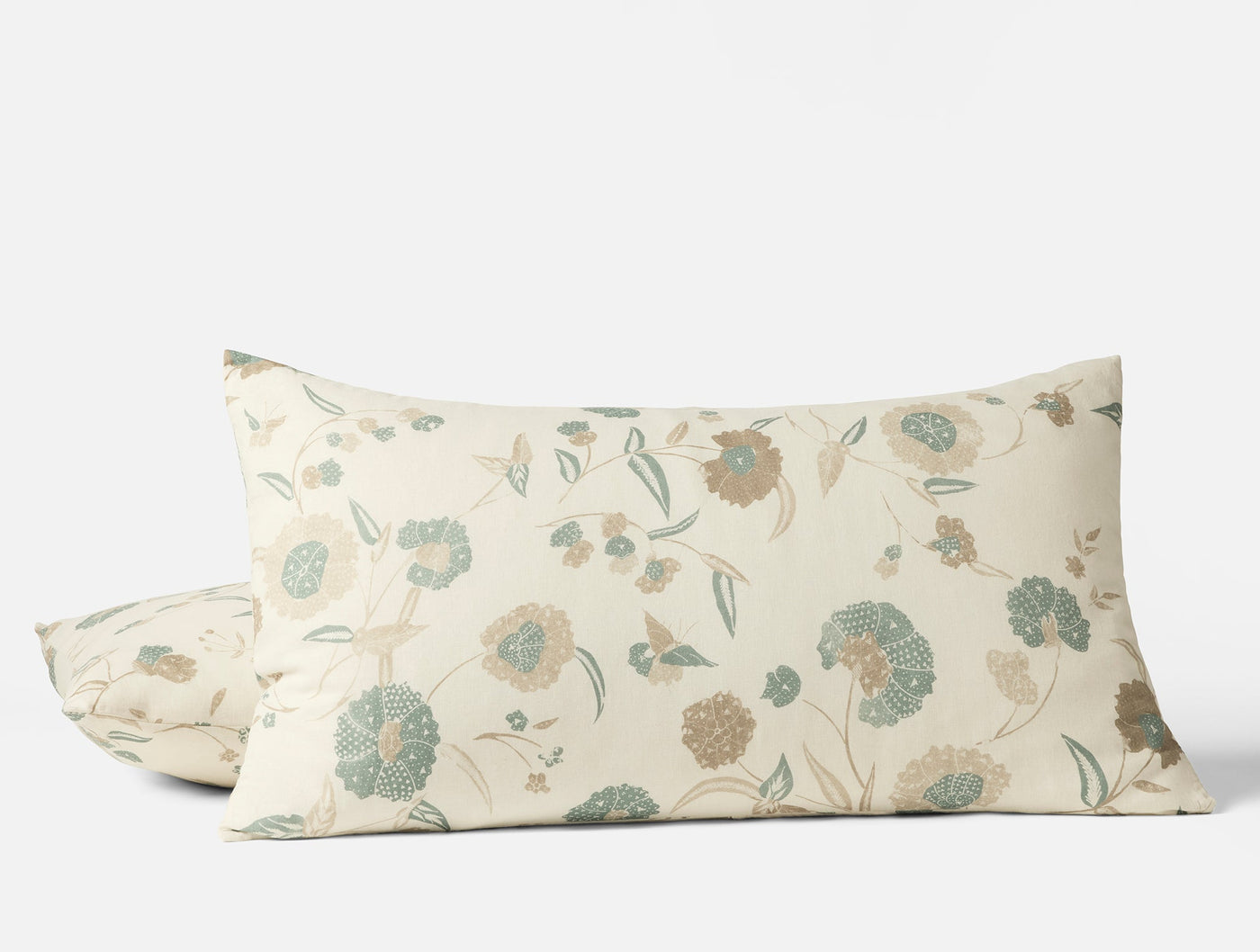 Two Coyuchi Aurora Print shams in ivory with sage and taupe floral pattern, stacked on white background.