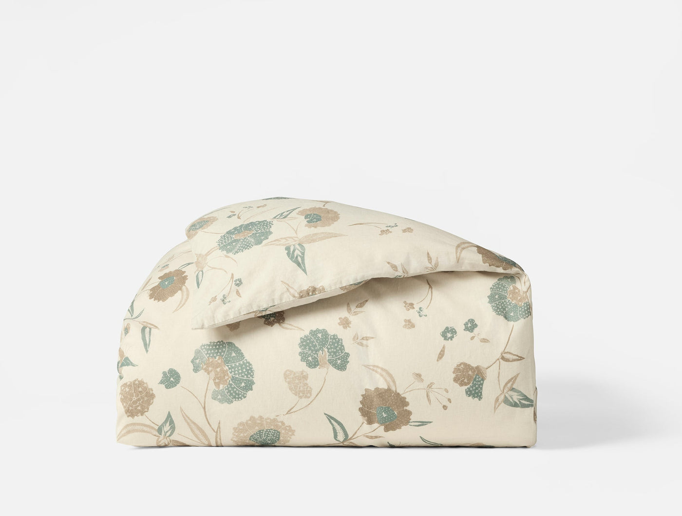 Coyuchi Aurora Print duvet cover in ivory with sage and taupe floral pattern, neatly folded.