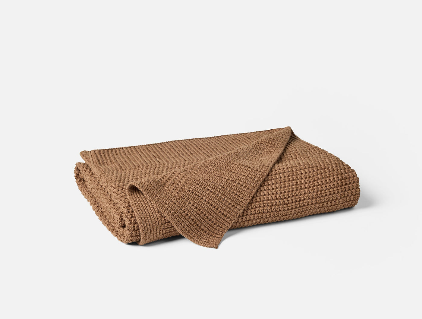 Coyuchi Avalon Knit throw in camel, folded to show waffle-knit texture.