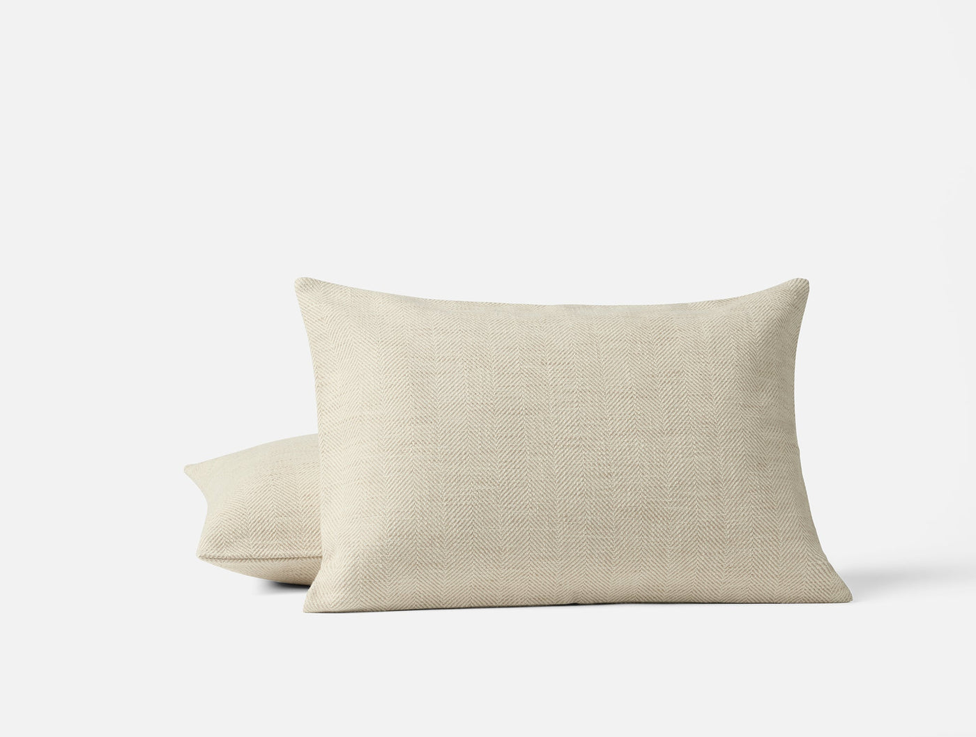 Pair of Coyuchi Canyon pillows in natural linen, stacked against white background.