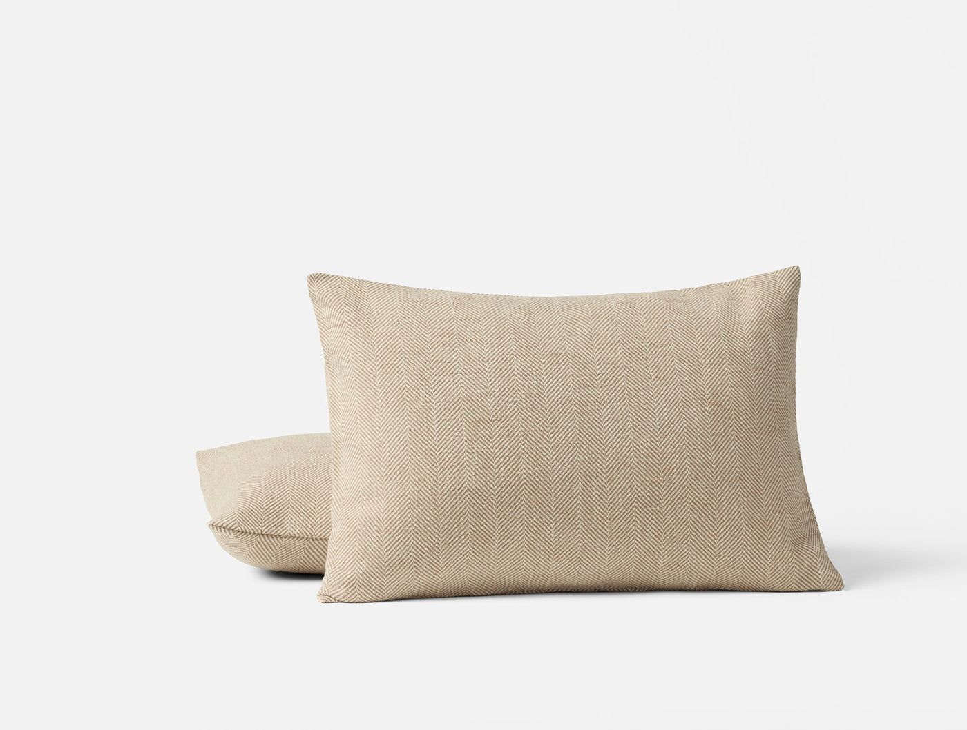 Pair of Coyuchi Canyon pillows in natural linen, stacked against white background.