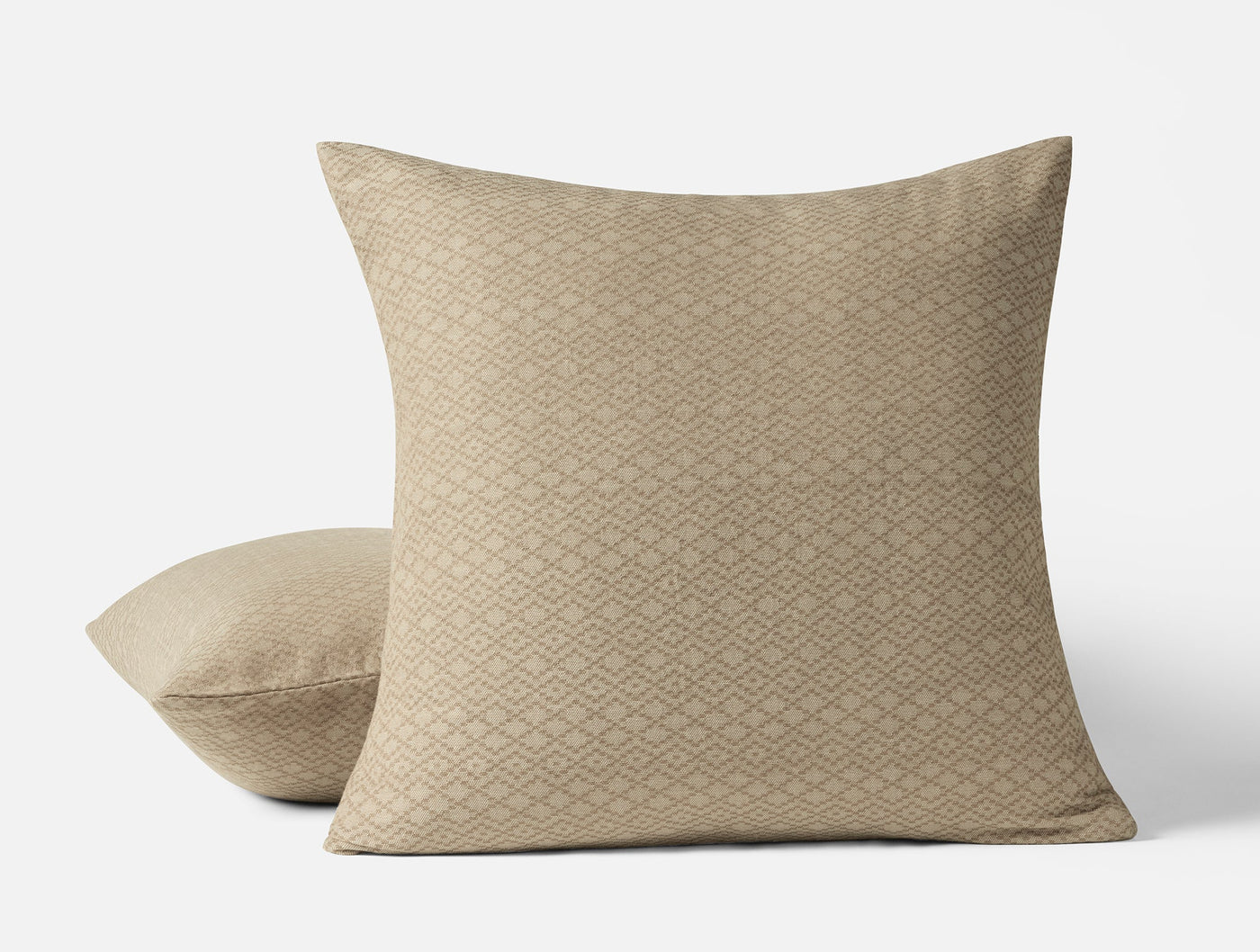 Close-up of two Capitola pillow shams in champagne with a diamond weave texture pattern.