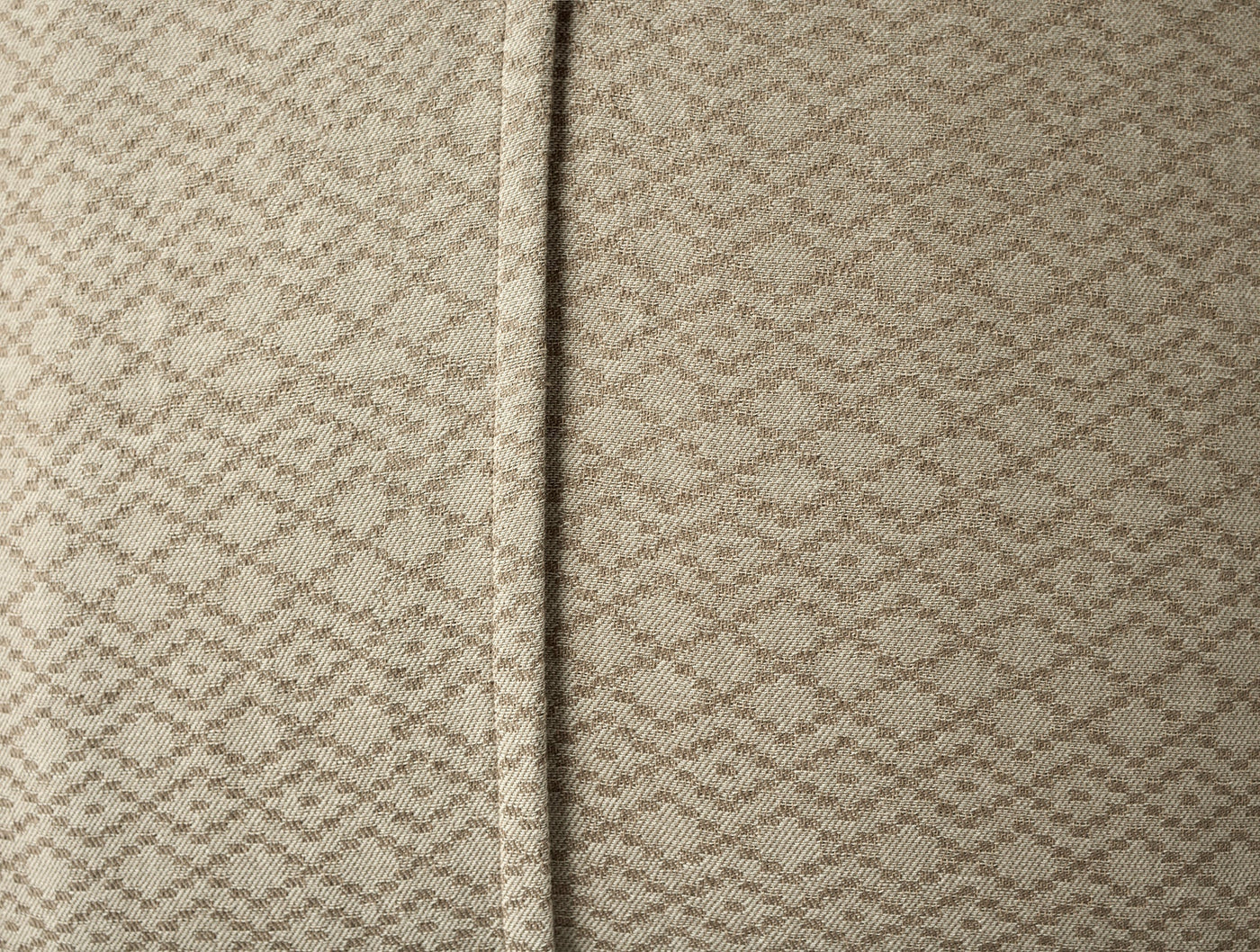 Close-up of Coyuchi Capitola sham seam detail showing woven diamond texture in natural linen.