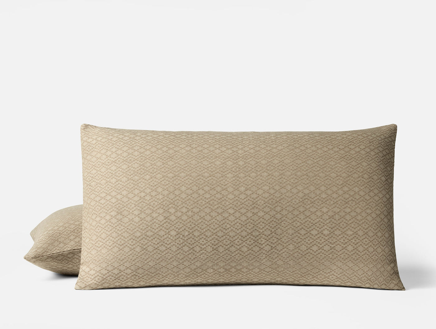 Capitola pillow sham in sand, geometric diamond jacquard weave, pair stacked on white background.