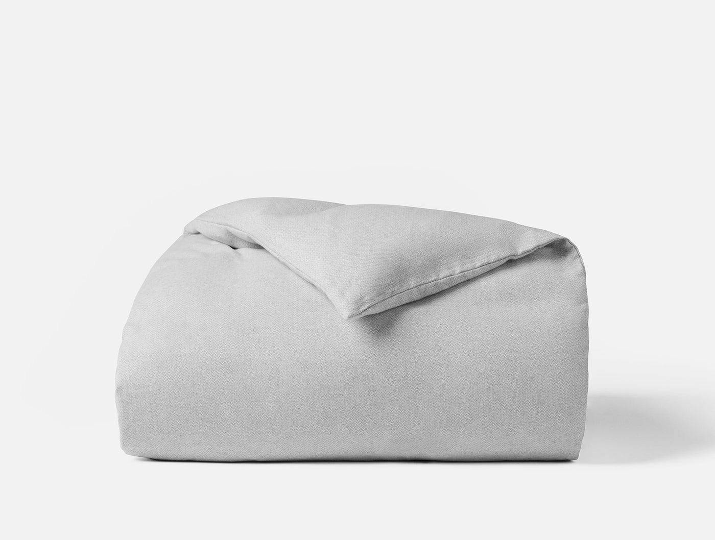 Close-up of folded silver grey flannel duvet cover with soft brushed texture.
