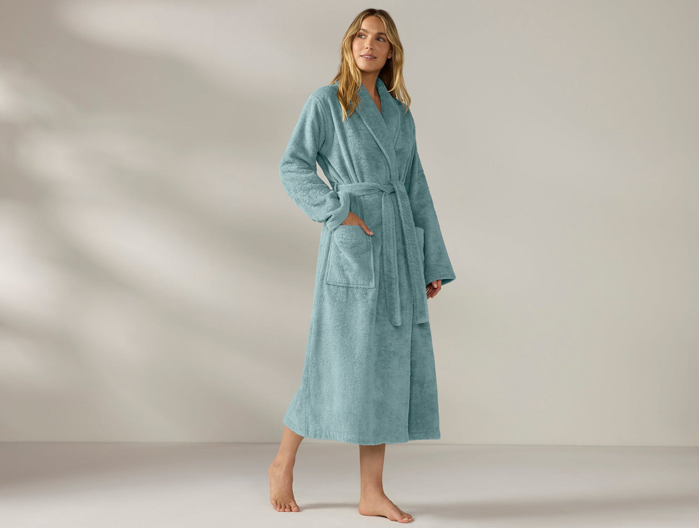 Coyuchi Cloud Loom robe in seafoam, full-length view on model with belt tied.