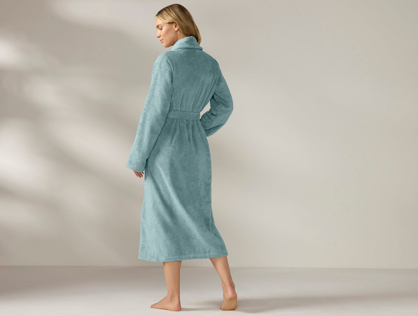 Back view of Coyuchi Cloud Loom robe in teal, full-length terry with belted waist.
