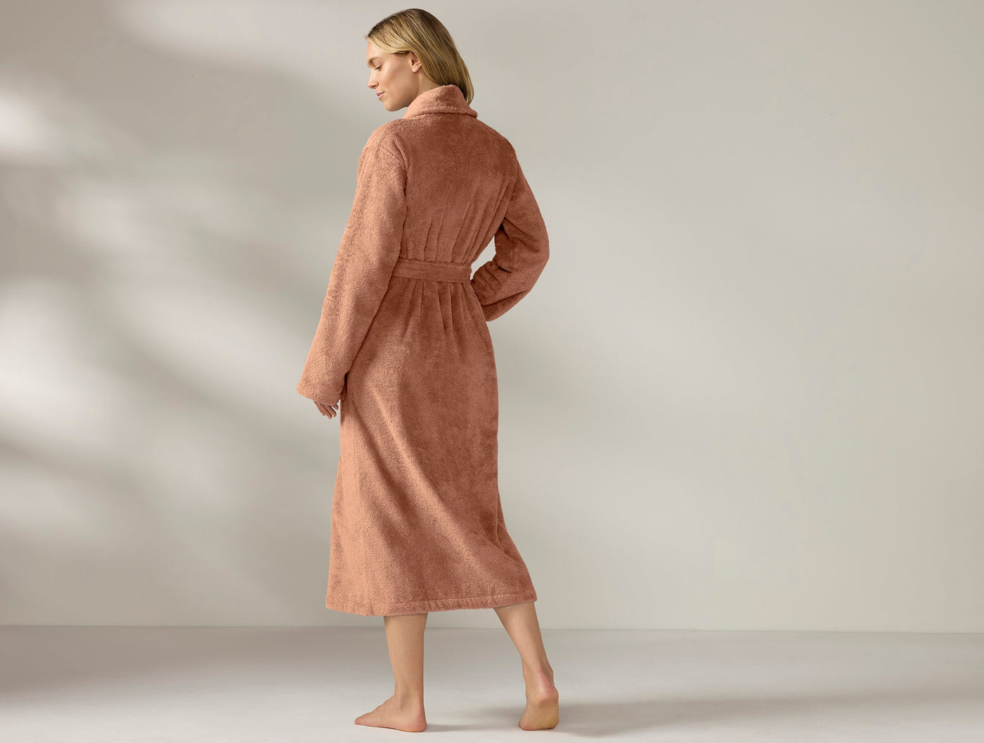 Back view of Coyuchi Cloud Loom robe in terracotta, floor-length with belted waist.
