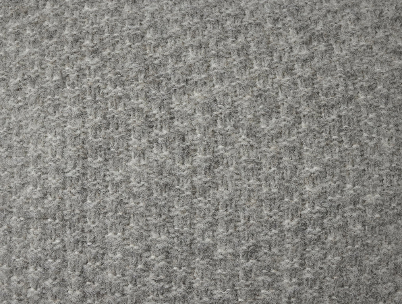 Close-up of Coyuchi Cordillera pillow's heathered grey alpaca-cotton houndstooth knit texture.