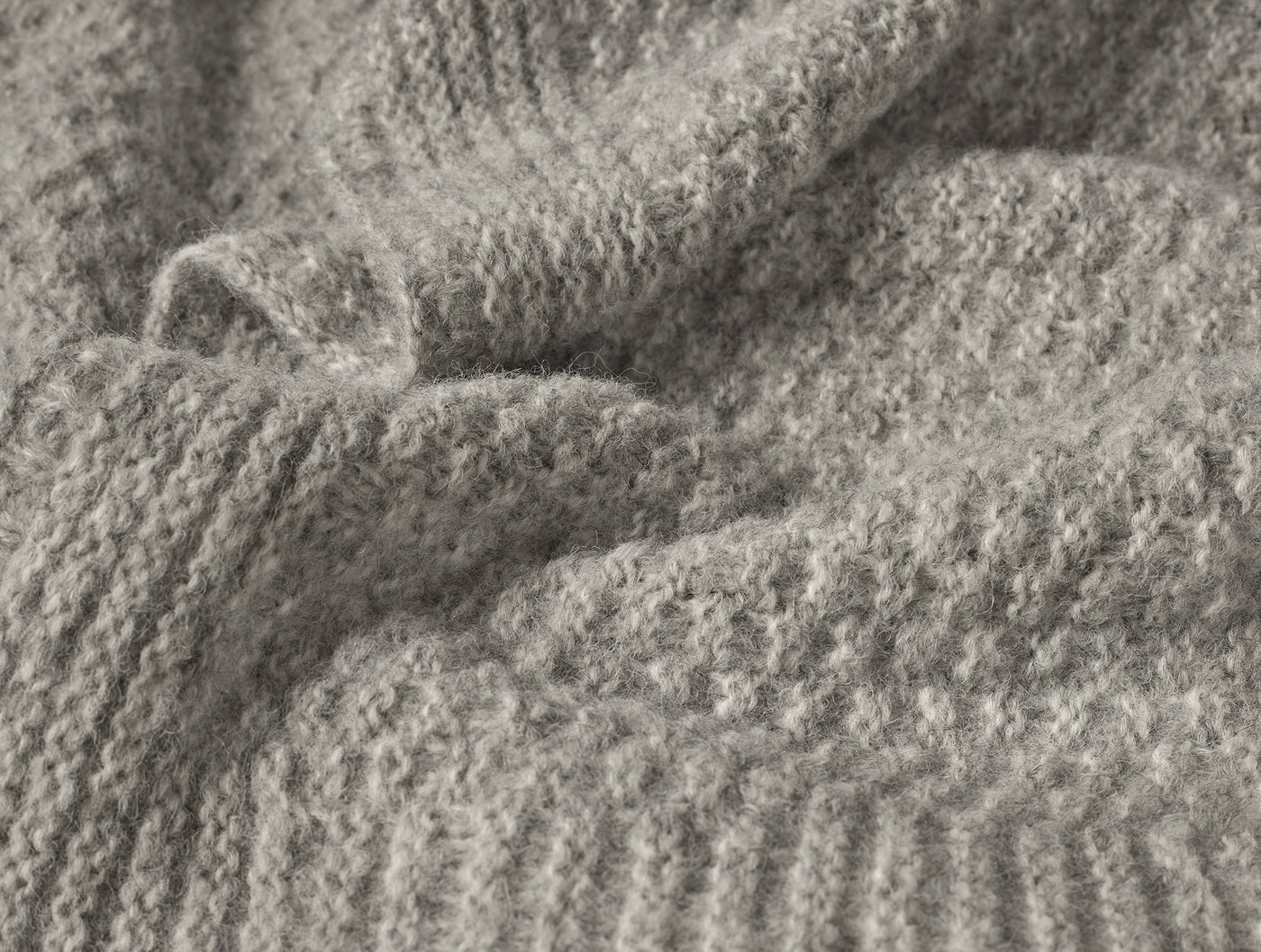 Close-up of Coyuchi Cordillera throw in dove grey, showing textured alpaca-cotton knit weave.