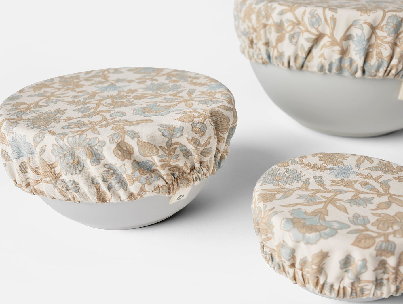 Coyuchi Conserve bowl covers in ivory with blue and tan botanical print, elasticized edges.