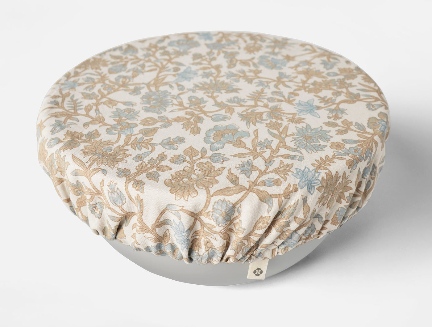Coyuchi bowl cover with ivory and blue botanical floral print, fitted over a round bowl.