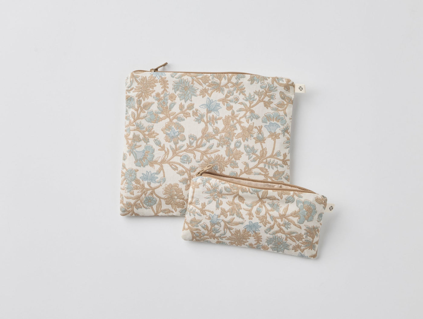 Two Coyuchi Conserve snack bags in floral blue and tan print, large and small sizes.