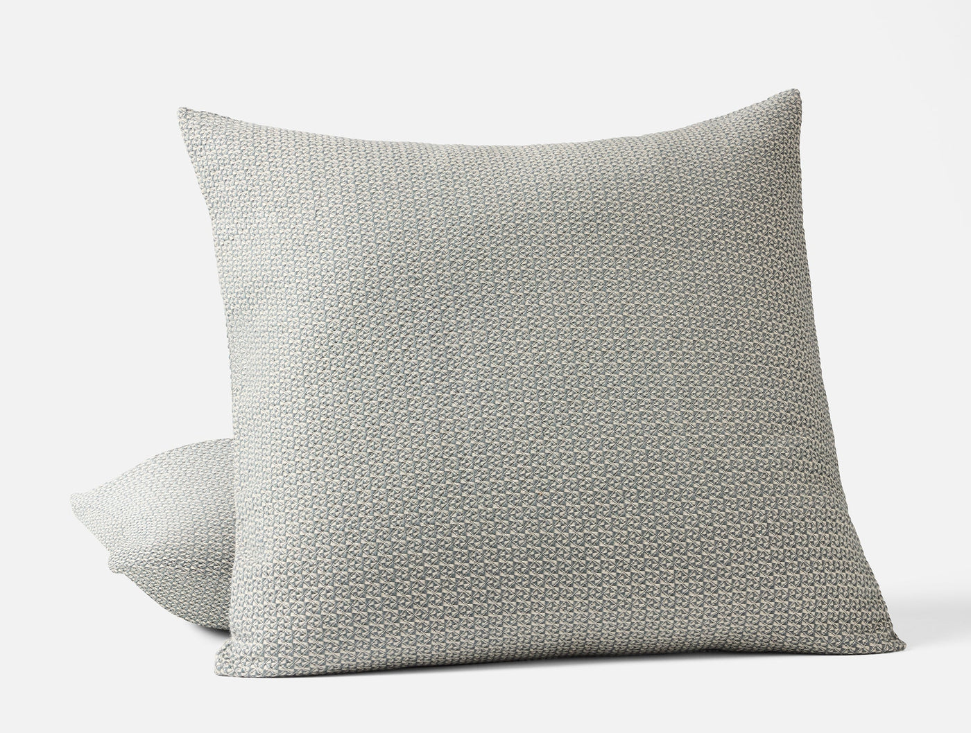 Close-up of Coyuchi Honeycomb sham in silver-grey, showing textured weave pattern on two stacked shams.