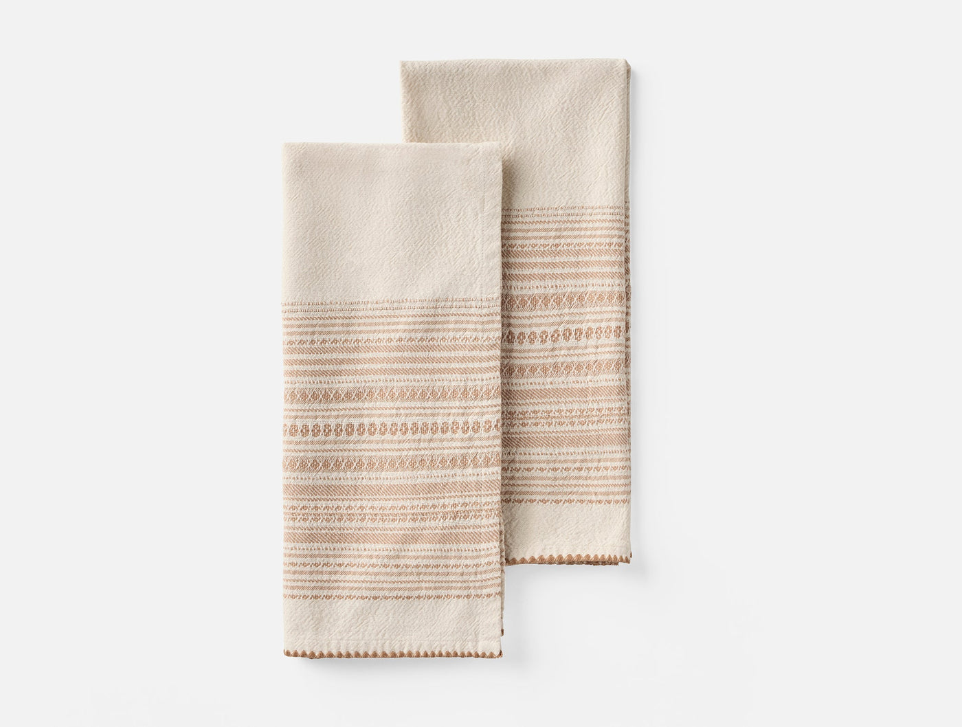 Pair of Coyuchi Oak hand towels in ivory with terracotta embroidered stripe detail.