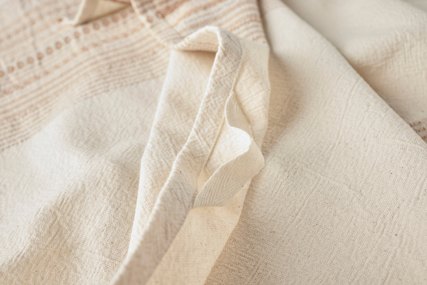 Close-up of ivory Coyuchi Oak hand towel loop and textured stripe weave detail.