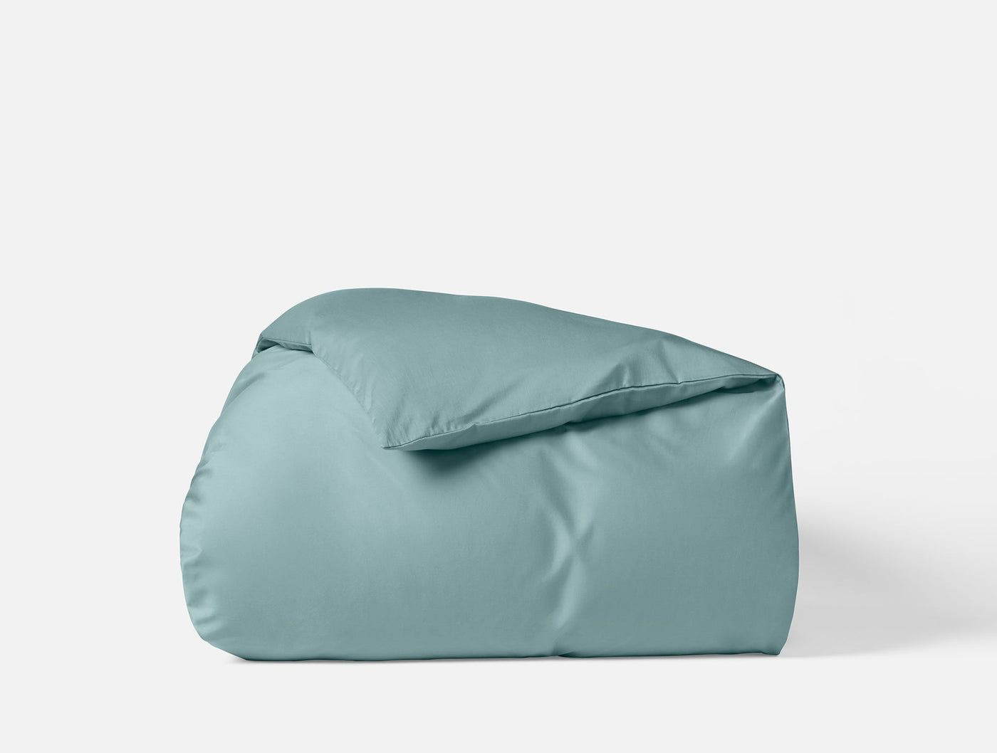 Coyuchi Cloud Soft Sateen duvet cover folded upright, muted teal, smooth sateen finish.