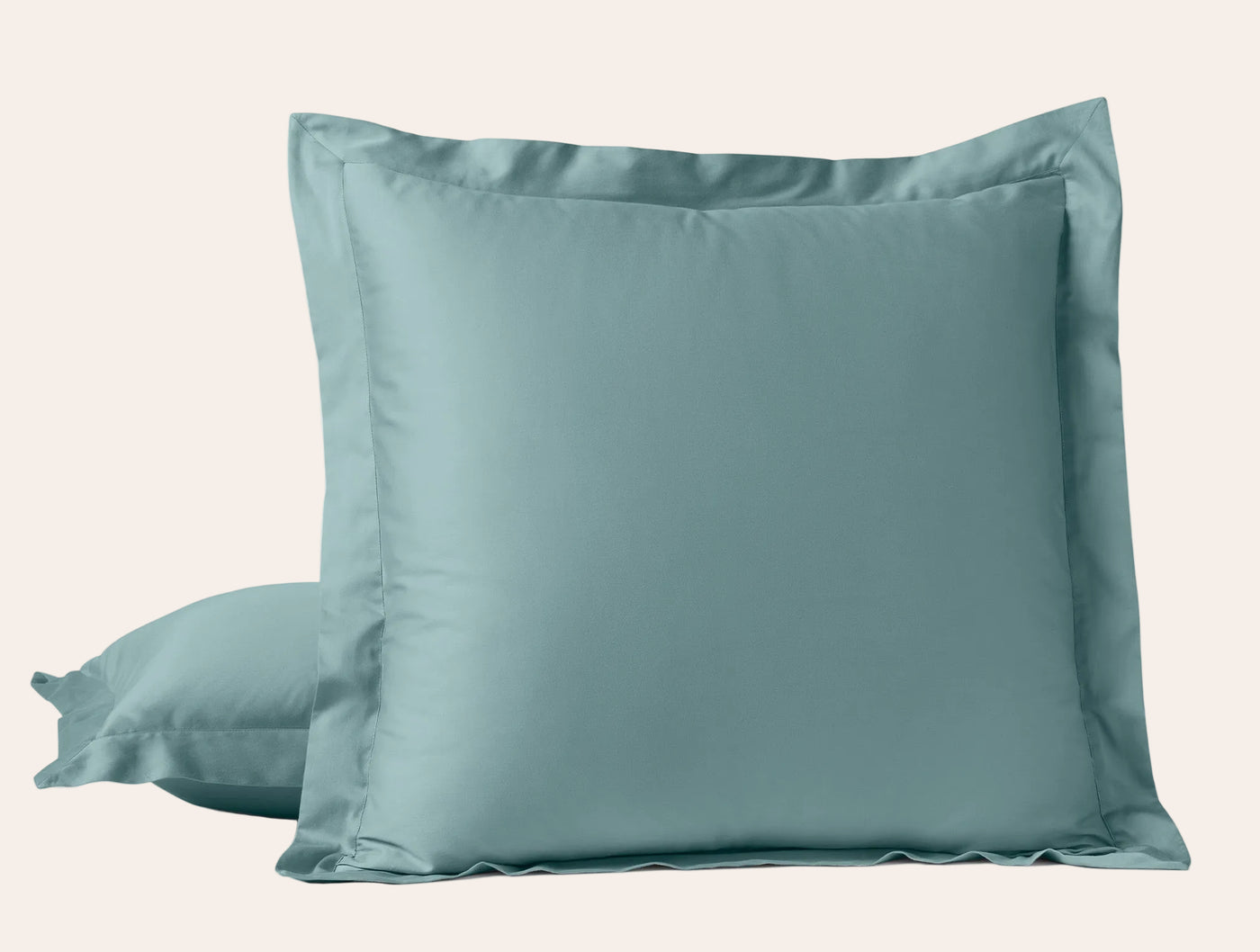 Two ocean blue sateen pillow shams with wide flanged border, stacked upright.