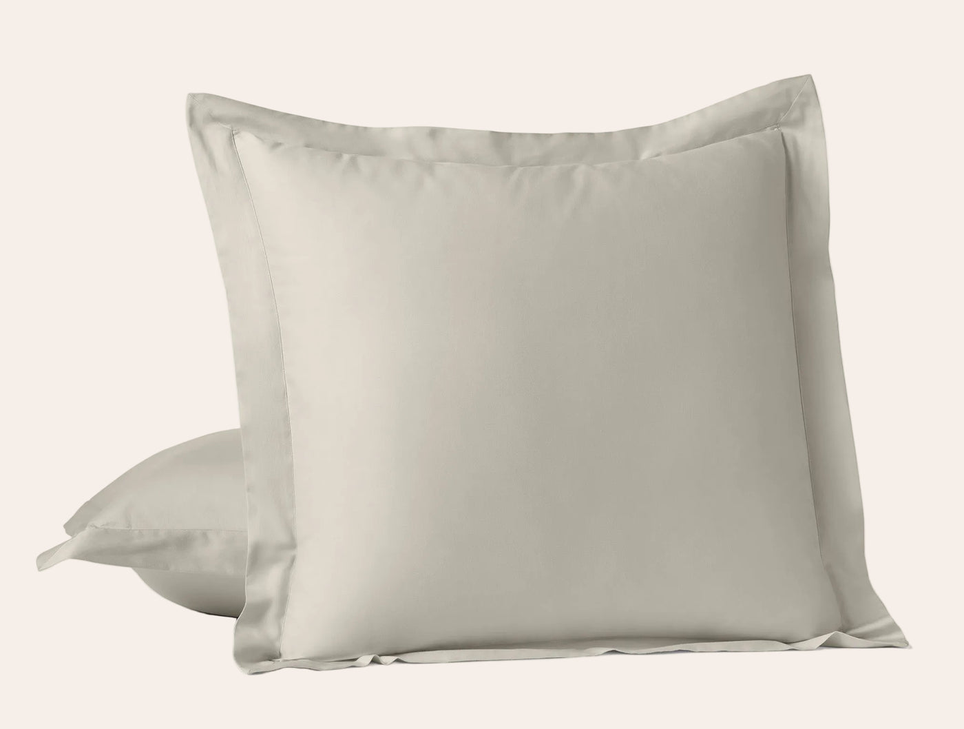 Close-up of Coyuchi Cloud Soft Sateen sham pair in warm linen, flange border detail visible.