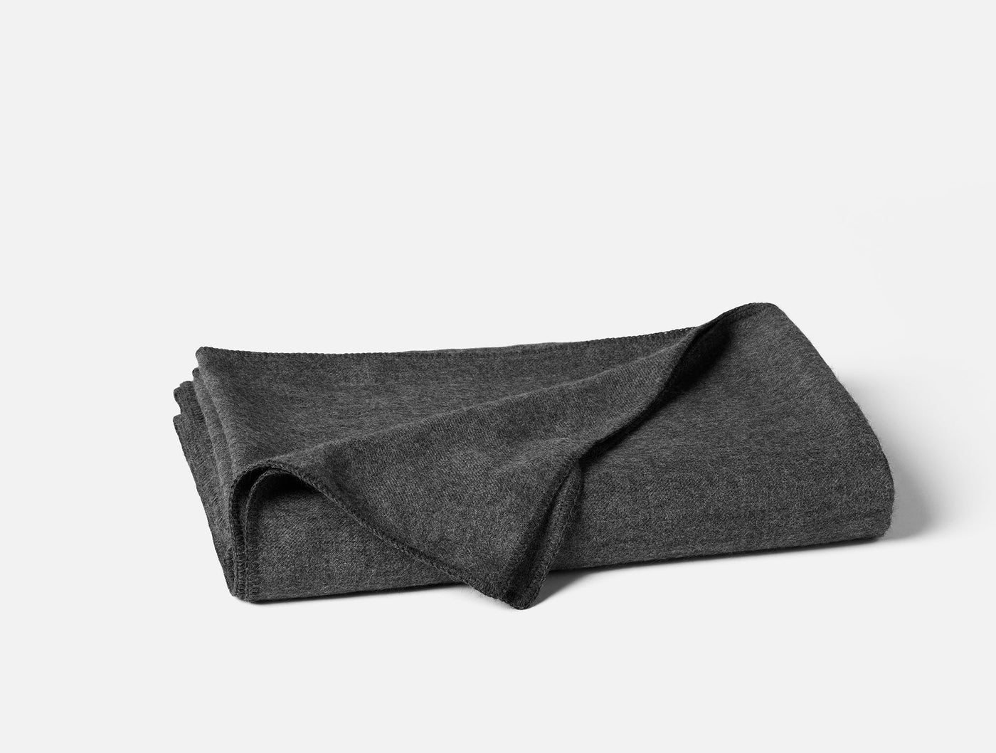 Coyuchi Pacaya Baby Alpaca blanket folded, charcoal heathered knit texture visible.