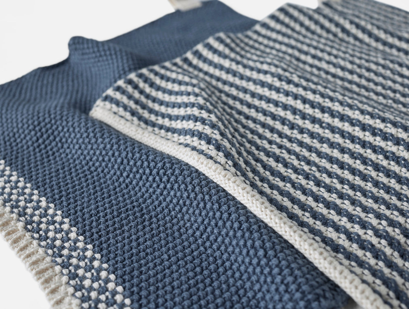 Close-up of Coyuchi Shasta dish cloths showing indigo and natural stripe and waffle knit textures.