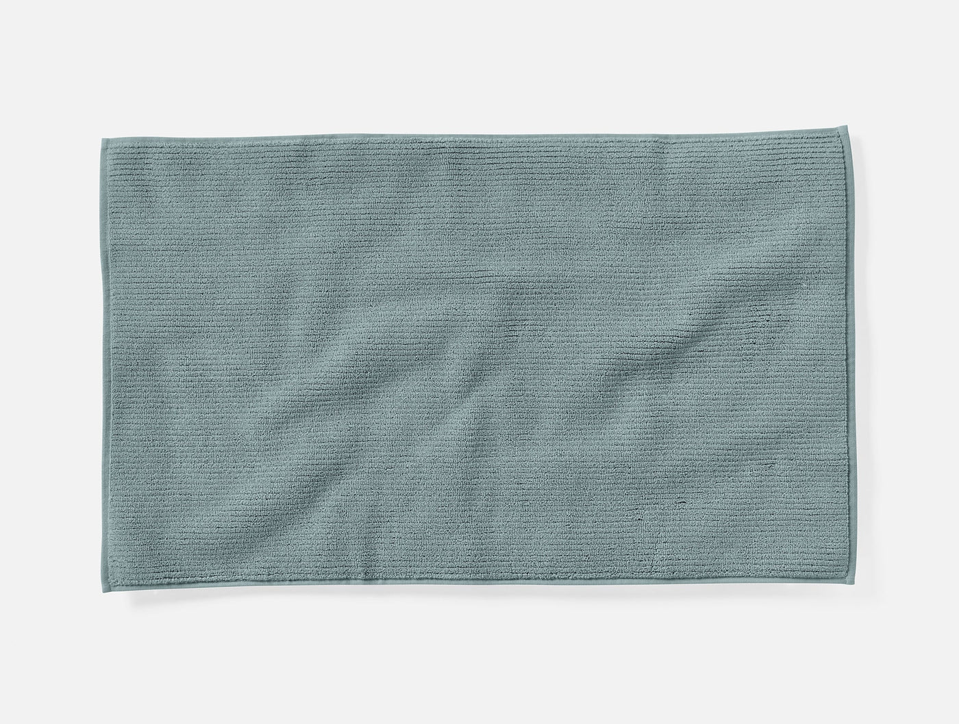 Coyuchi Temescal bath rug in slate blue, textured ribbed weave, flat lay view.