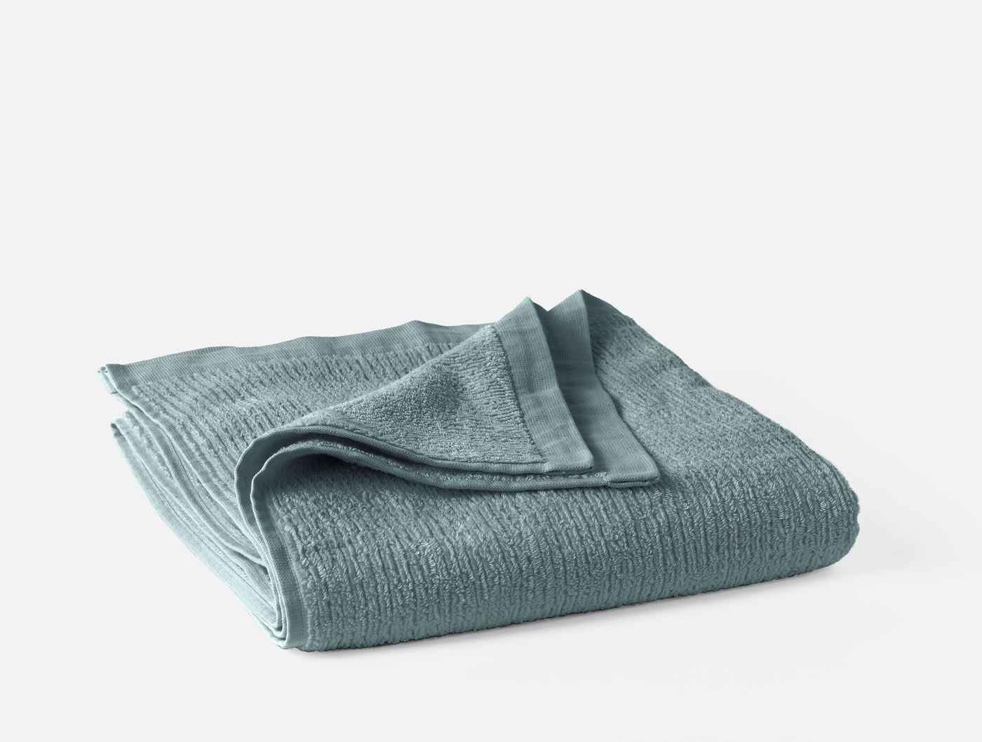 Folded seafoam Coyuchi Temescal ribbed towel showing textured rib weave detail.