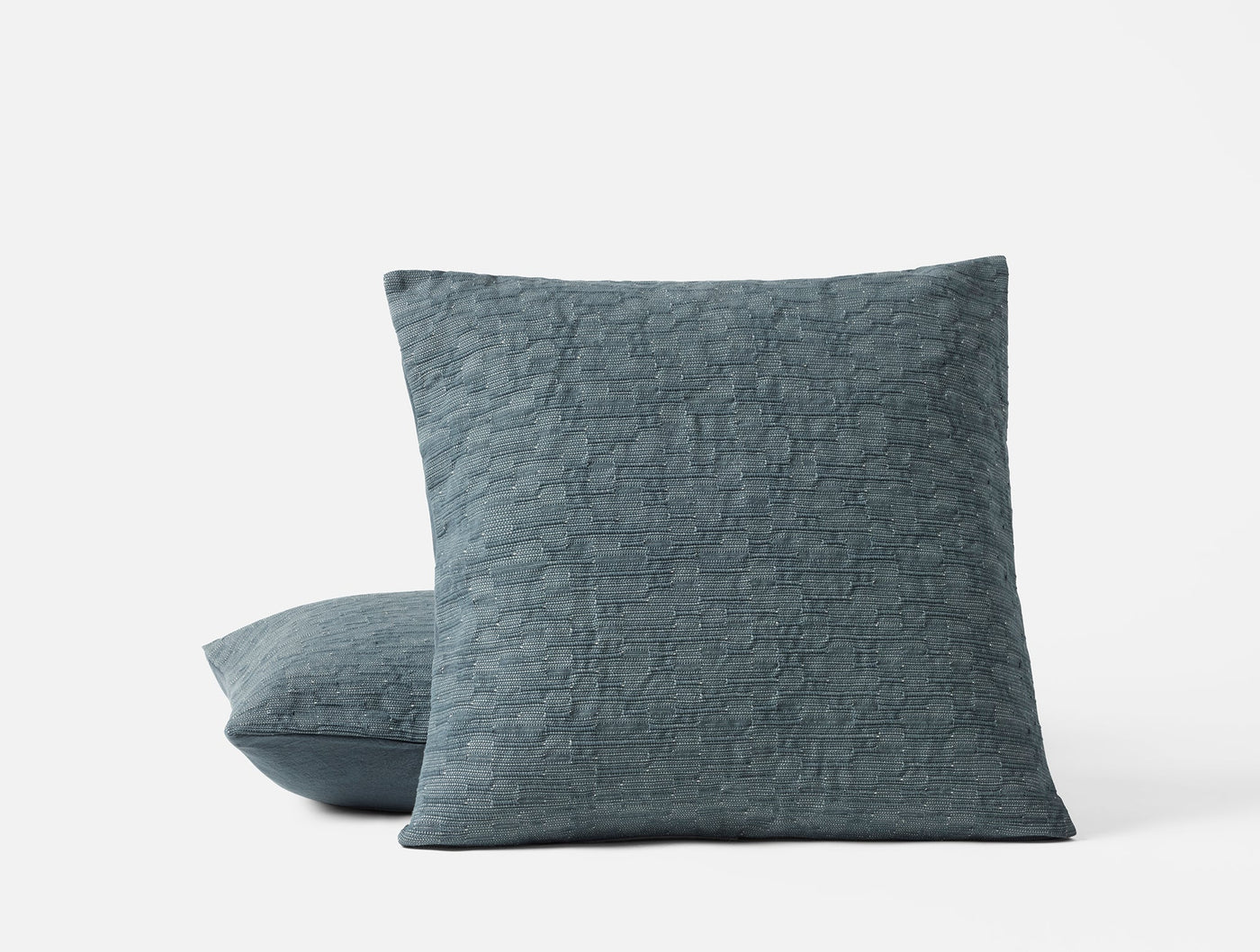 Coyuchi Toro Canyon pillow covers in slate blue with quilted crinkle texture, stacked pair.