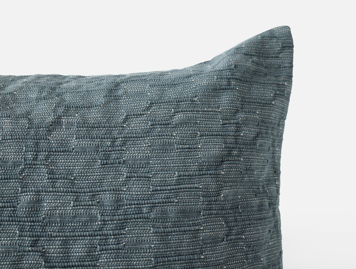 Close-up of Coyuchi Toro Canyon pillow corner showing slate blue woven texture detail.