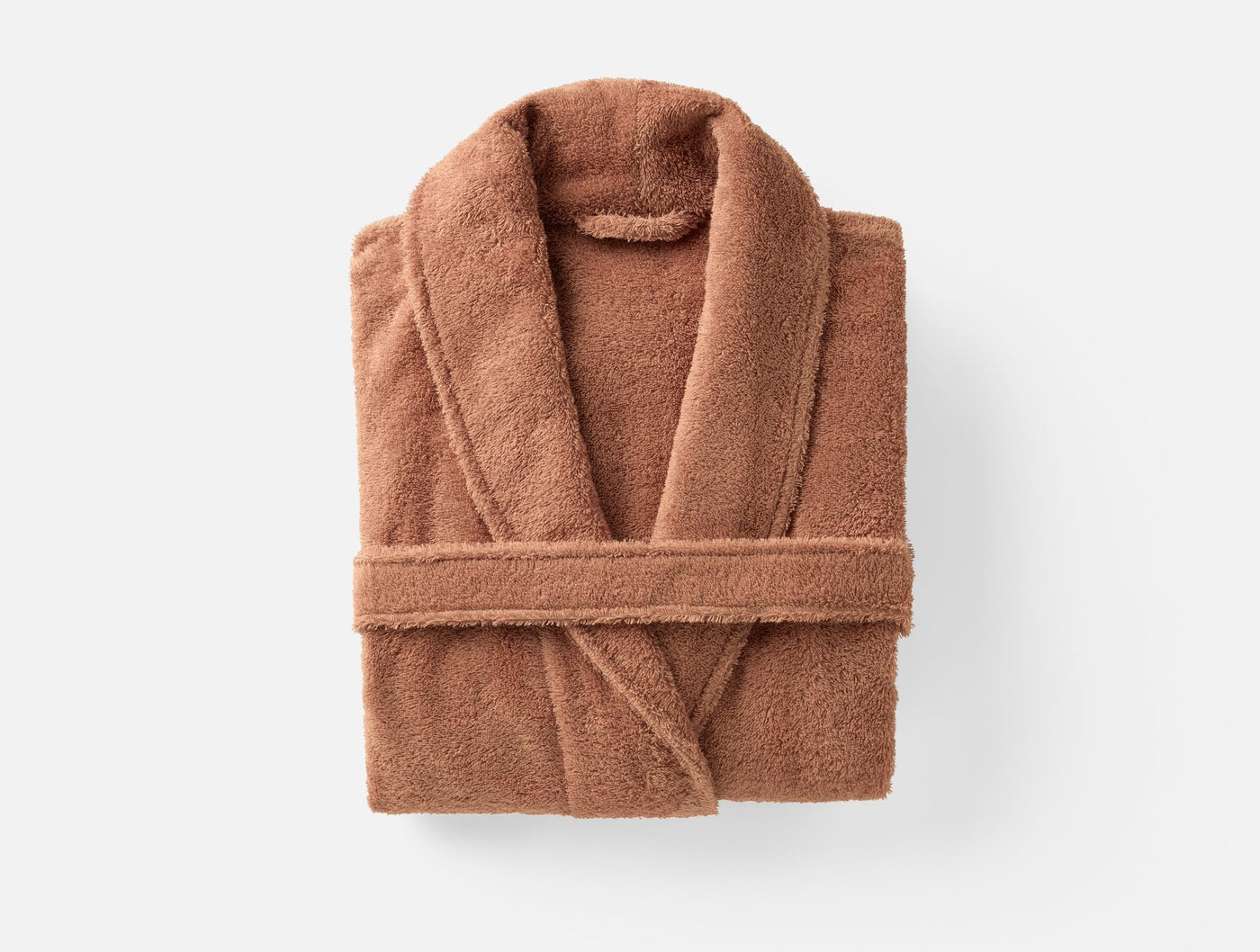 Coyuchi Cloud Loom robe in terracotta, folded flat overhead view showing shawl collar.