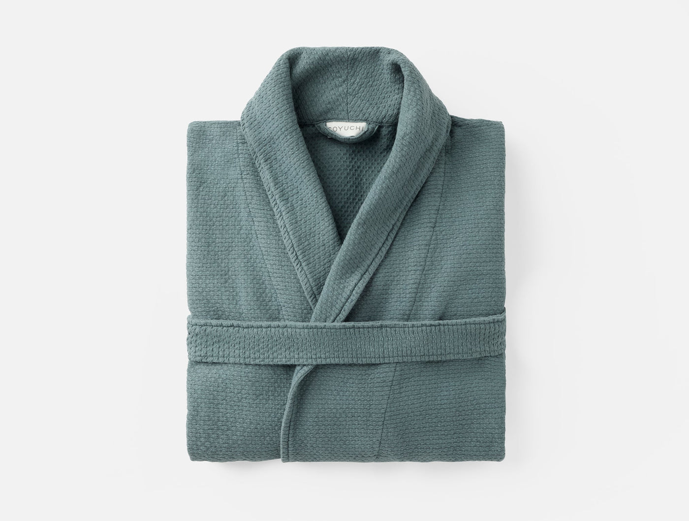 Coyuchi Adriatic robe in sage green waffle cotton, folded flat with belted waist.