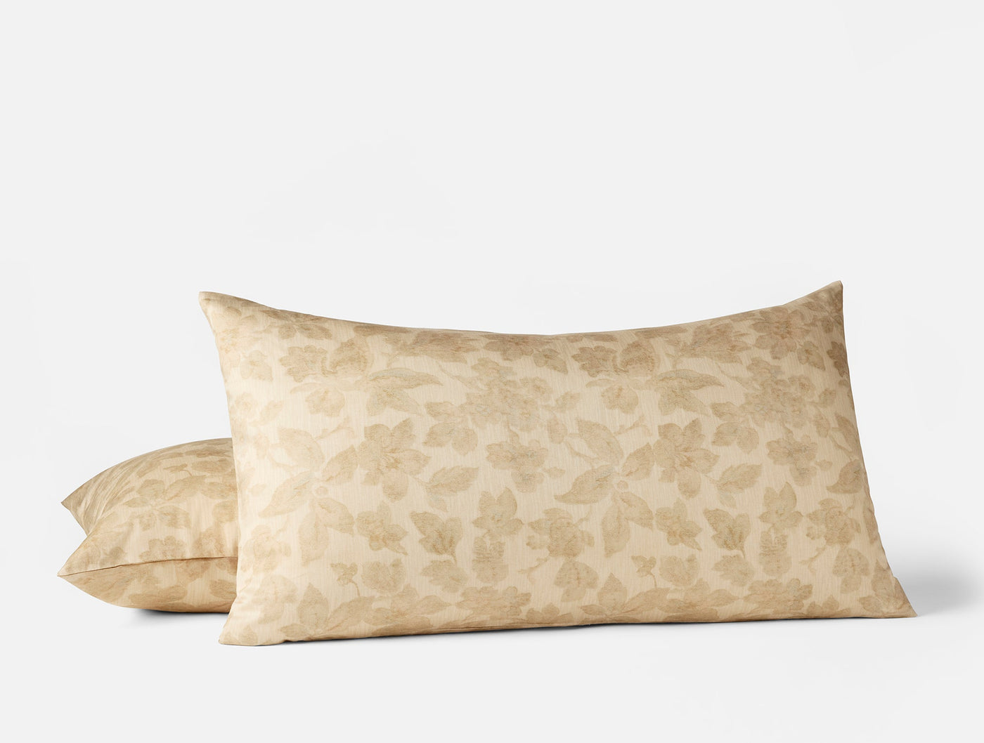 Camellia Print pillow shams in champagne, featuring a tone-on-tone floral leaf jacquard pattern.