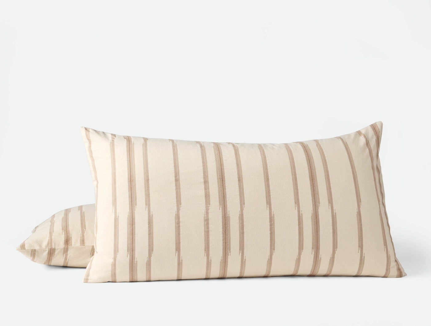 Pair of Coyuchi Cazadero Stripe shams in ivory with warm tan brushstroke stripes, front view.