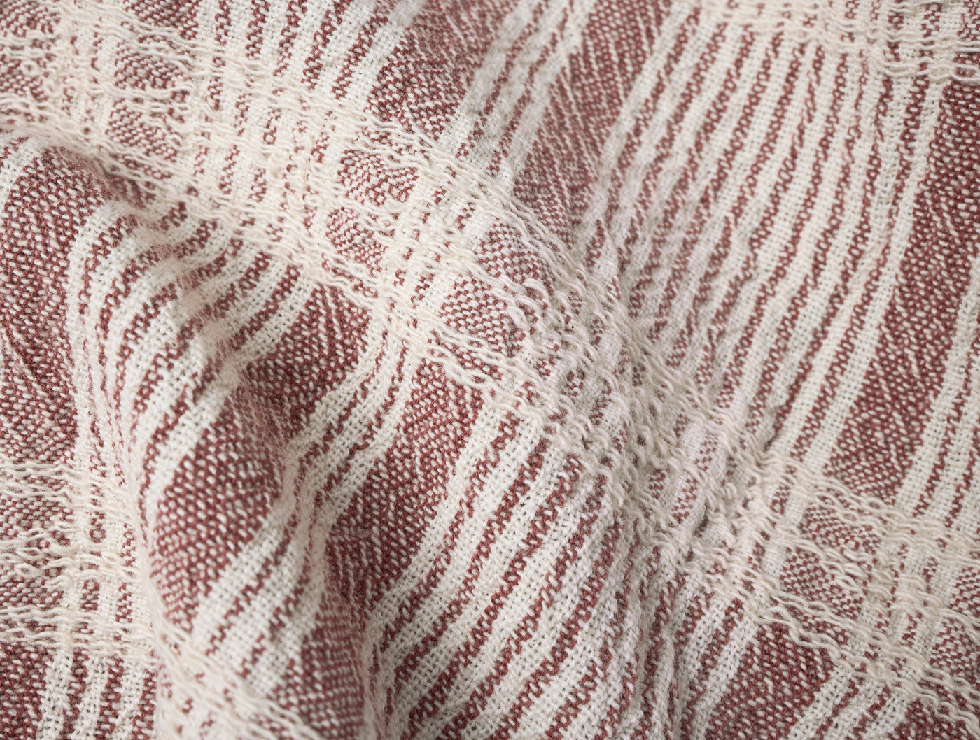 Close-up of dusty rose and ivory woven plaid texture on Coyuchi Clarendon kitchen towel.
