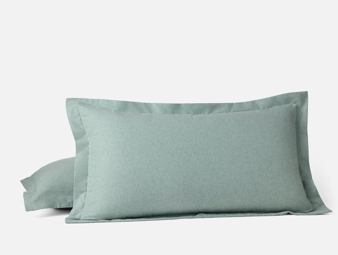 Sage green flannel pillow sham with tailored flange border, paired set angled view.