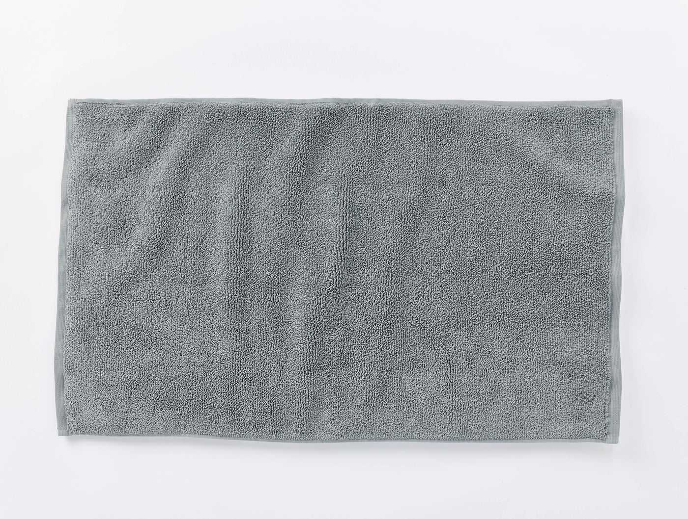 Coyuchi Cloud Loom bath rug in slate, overhead flat lay showing plush terry texture.