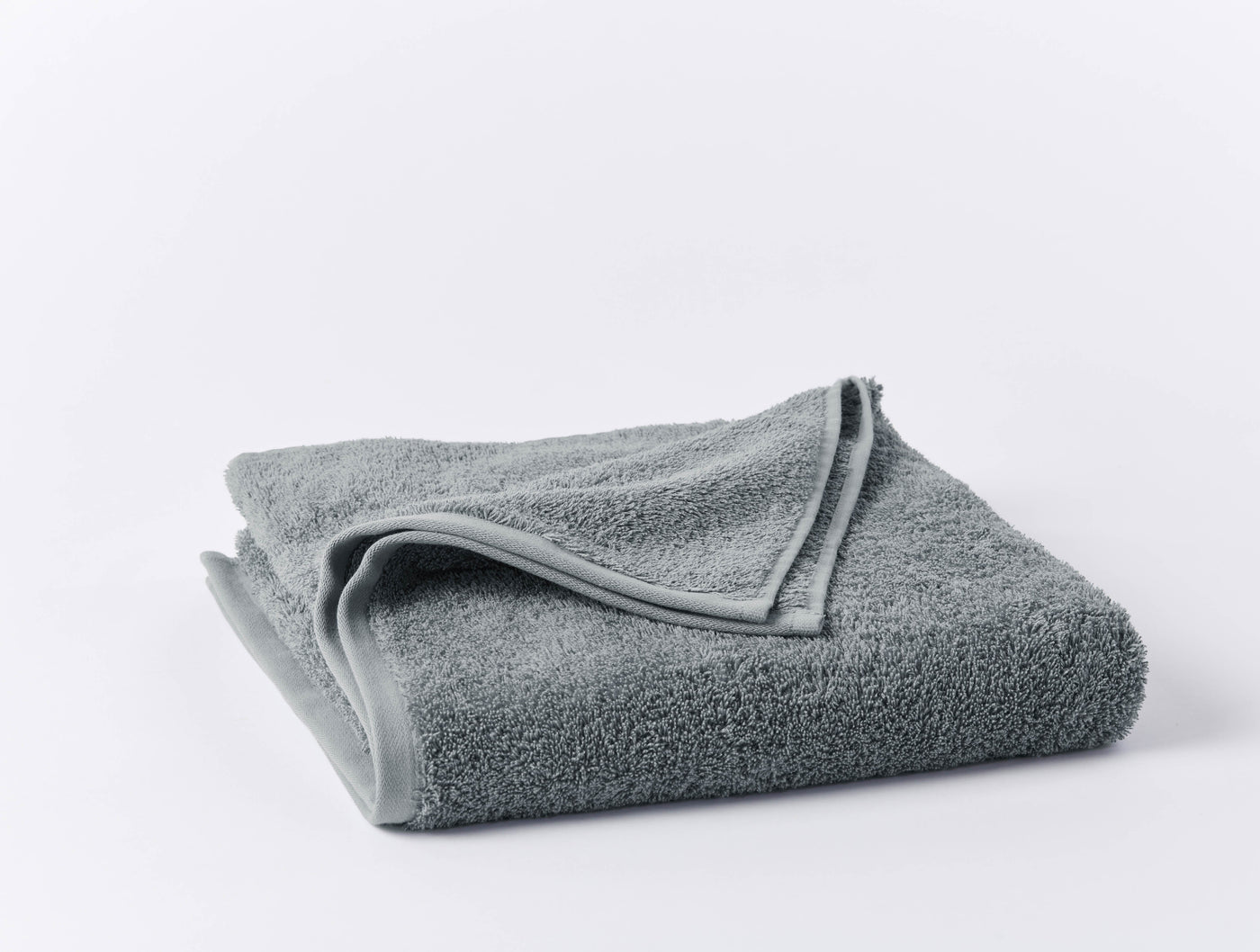 Coyuchi Cloud Loom wash cloth in slate, folded to show plush terry texture.